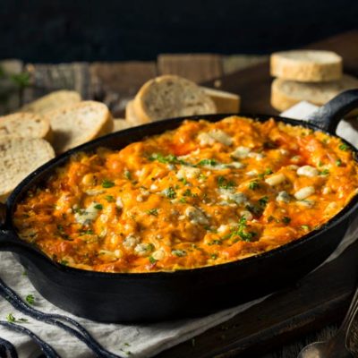 buffalo Chicken Dip in cast iron pan with bread