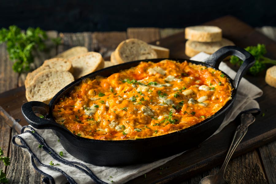buffalo Chicken Dip in cast iron pan with bread