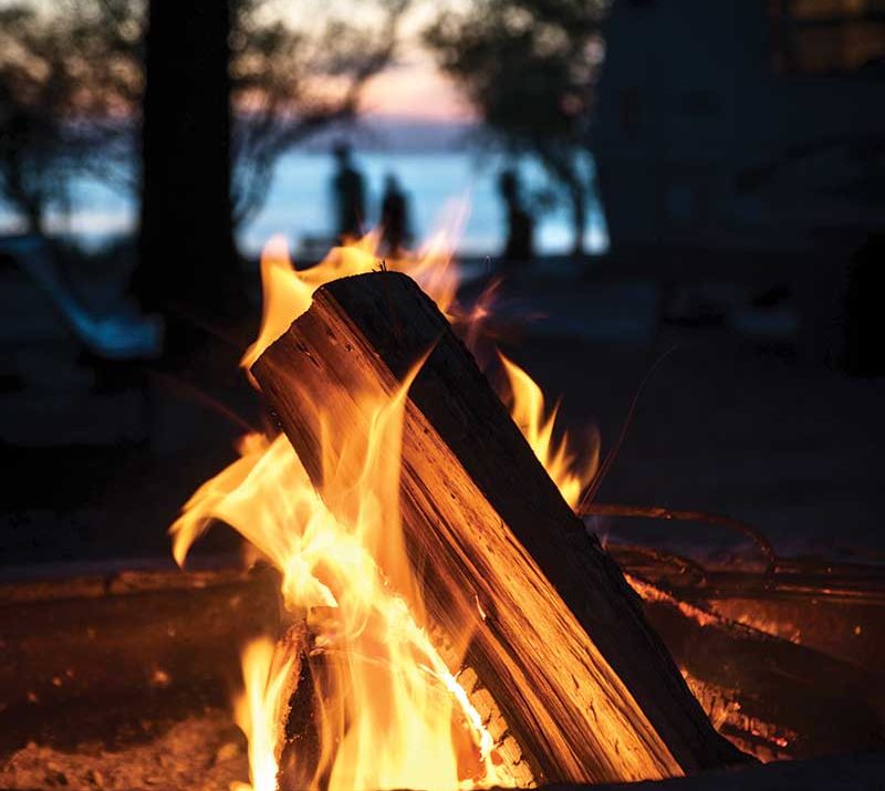 A campfire by a lake