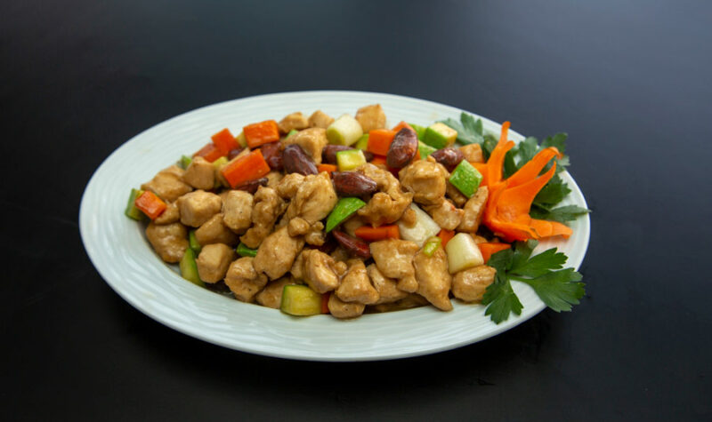 Stir Fry Chicken and vegetables on a white plate.