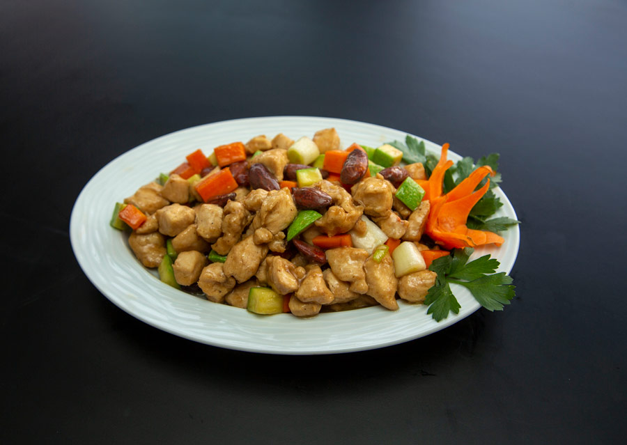 Stir Fry Chicken and vegetables on a white plate.
