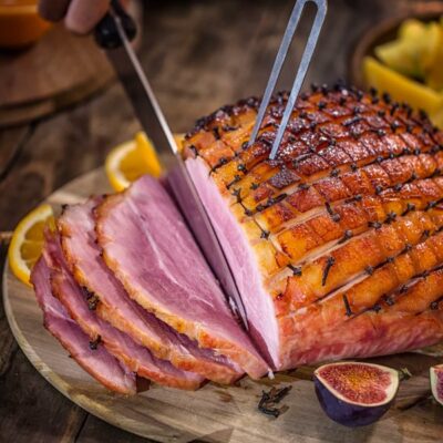 A ham roast being cut into.