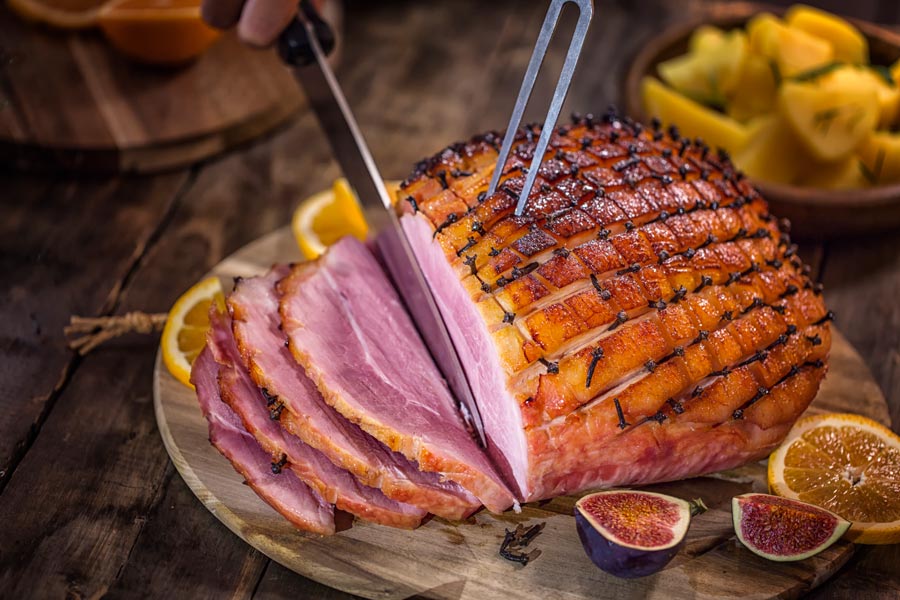 A ham roast being cut into.