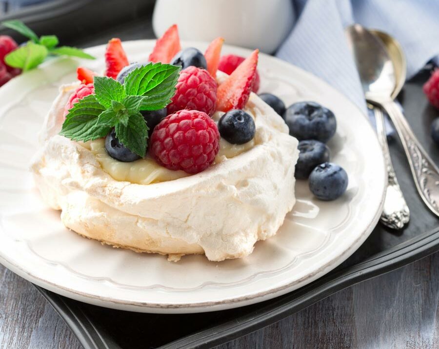 Pavlova topped with fresh berries.