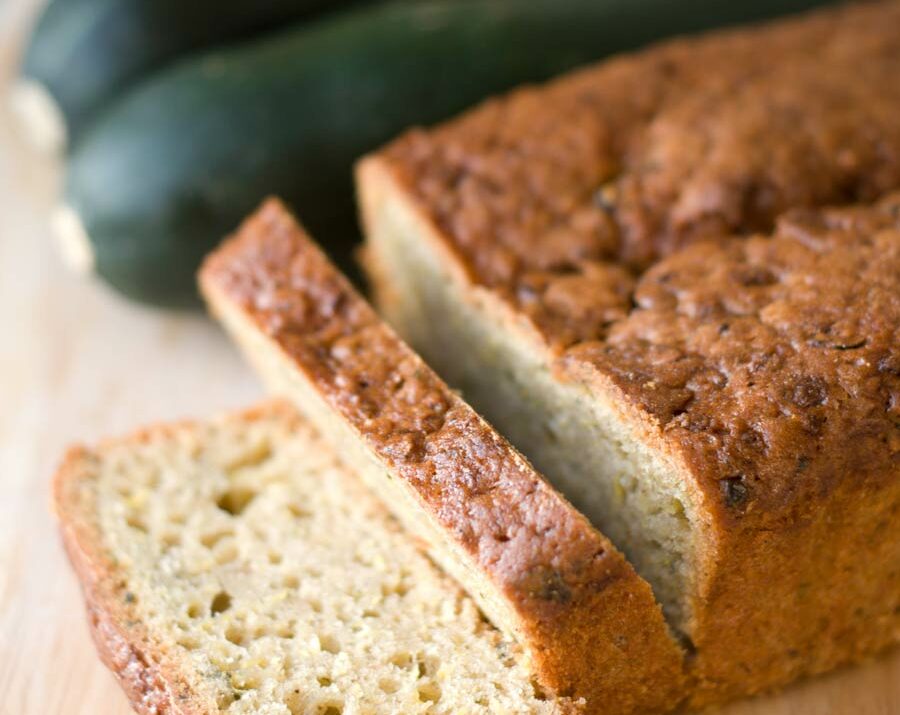 A loaf of zucchini bread on a cutting board.