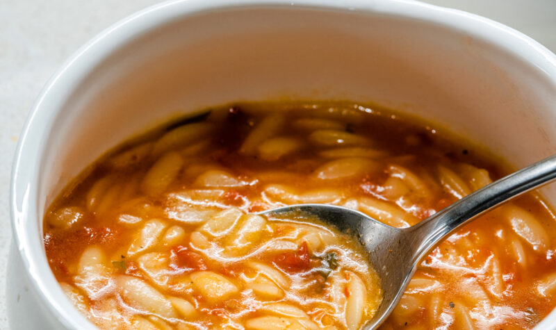 A bowl of tomato soup with orzo