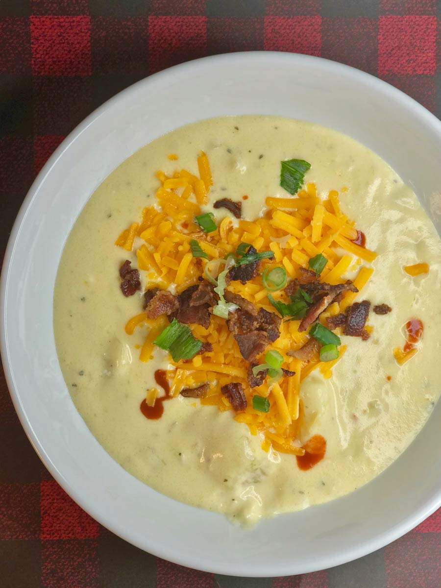 Creamy potato soup with cheese and bacon bits on top