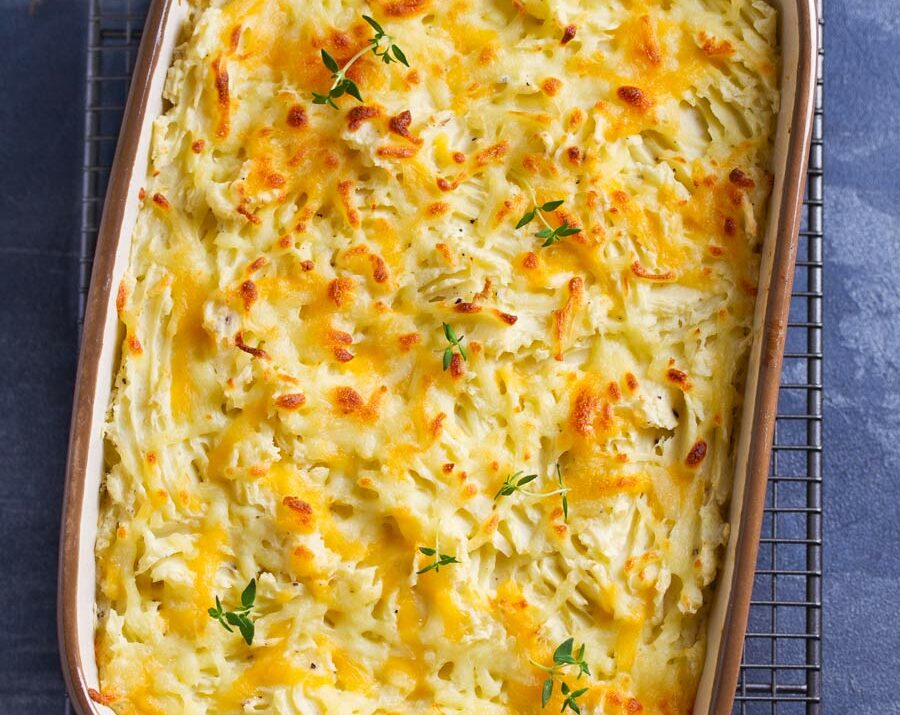 An overhead shot of a baking pan filled with creamy mashed potatoes.