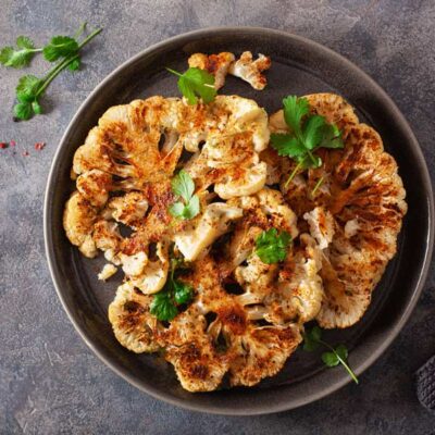 Grilled cauliflower on a plate.