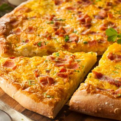 Breakfast pizza with bacon and eggs on crust