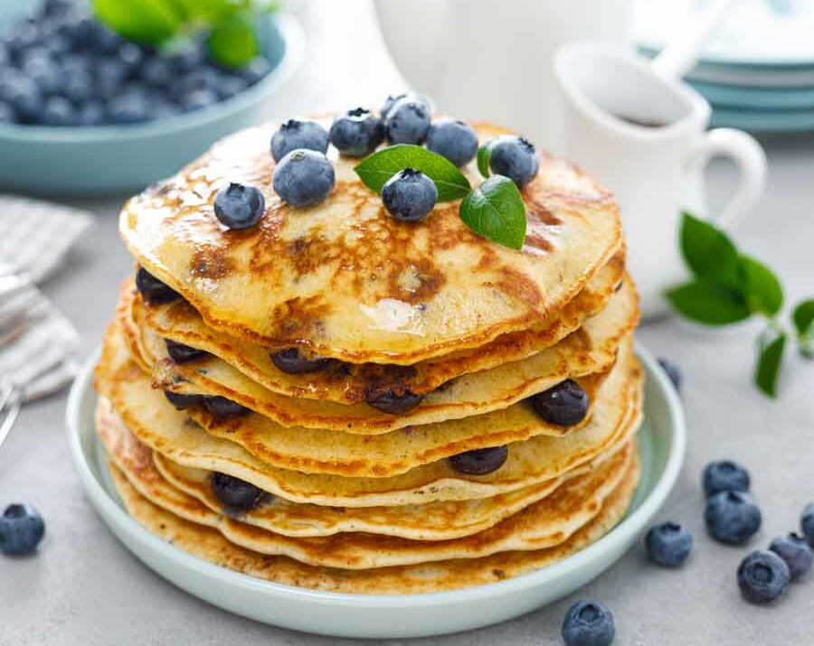 Blueberry pancakes with fresh blueberries and mint on top