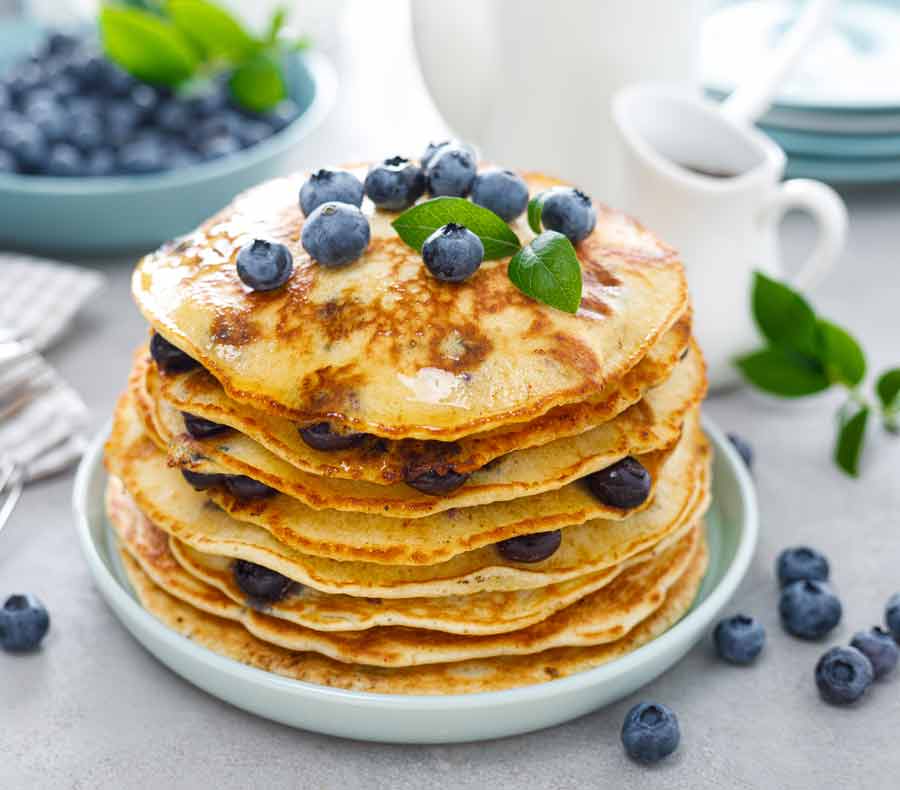 Blueberry pancakes with fresh blueberries and mint on top
