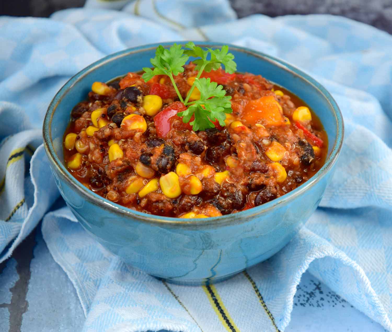 Vegetarian chili with black beans in a blue bowl