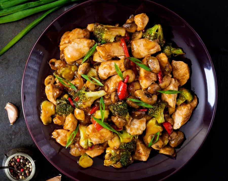 Chicken stir fry with veggies in a wok