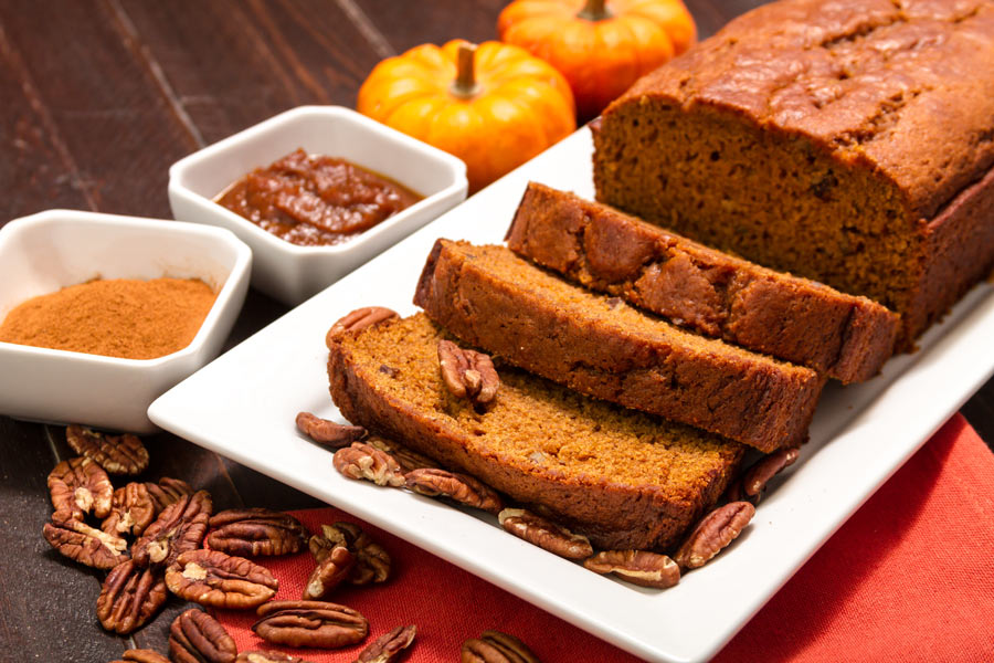 Pumpkin Bread on a white plate with nuts