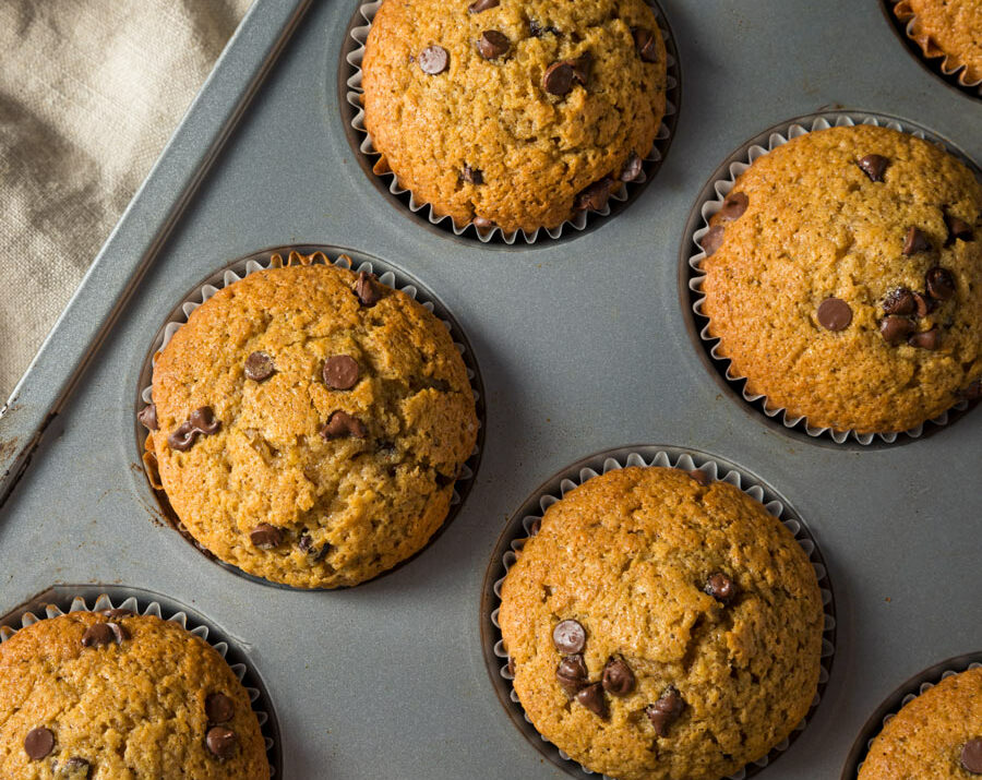 Pumpkin chocolate chip muffins in a baking pan