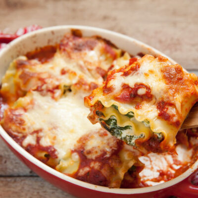 Spinach rollups in a read casserole dish