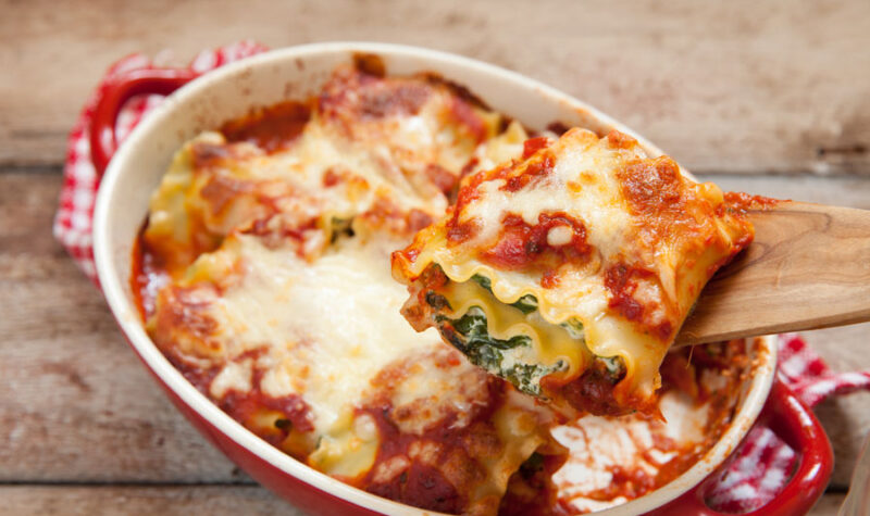 Spinach rollups in a read casserole dish