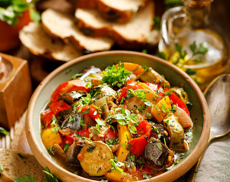 Easy Veg Ratatouille in a brown bowl with bread.