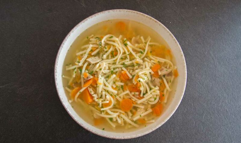 Chicken noodle soup in a white bowl