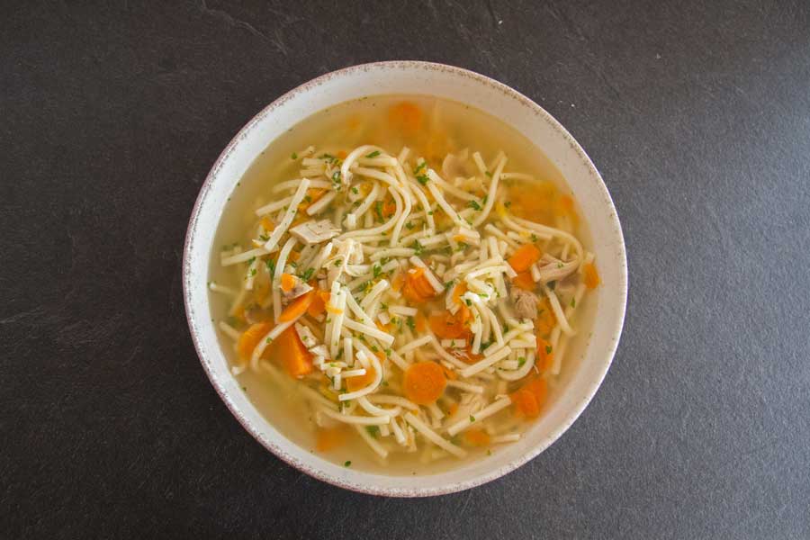 Chicken noodle soup in a white bowl