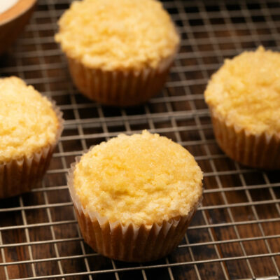 Lemon Crumb Muffins on a gold baking sheet