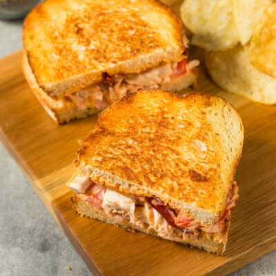 Southwest Panini sandwich on a cutting board with chips