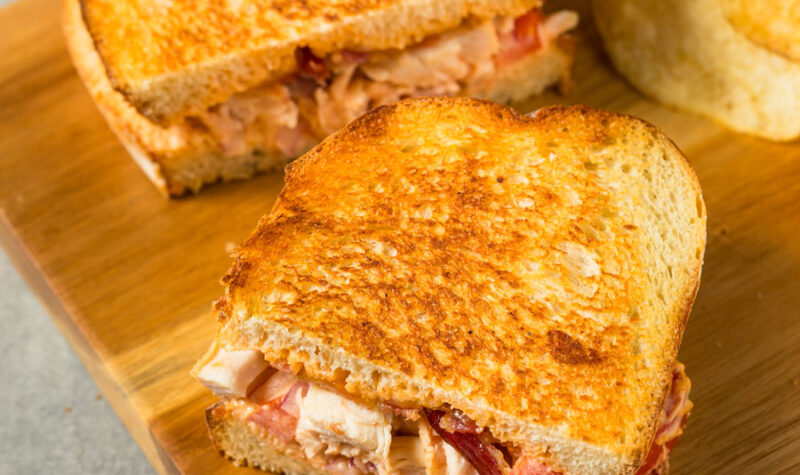 Southwest Panini sandwich on a cutting board with chips
