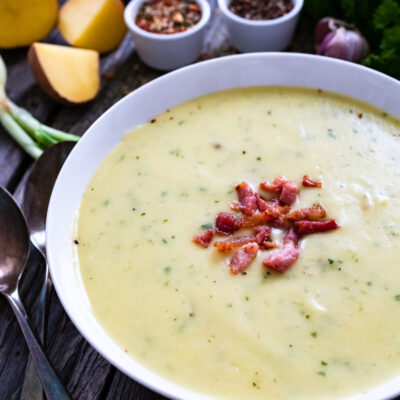 Potato soup in a white bowl with bacon pieces