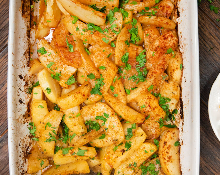Greek Roasted Potatoes in a casserole dish sprinkled with paprika
