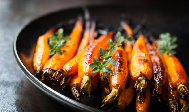 Baked Baby Carrots with Thyme - stock photo