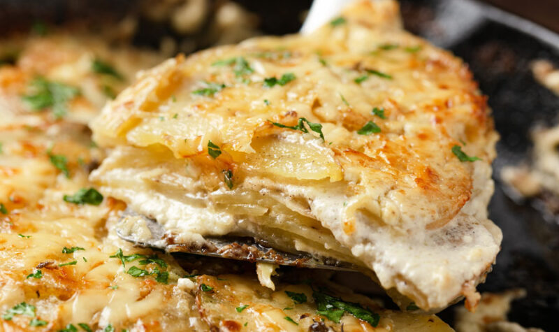 A closeup image of sheet pan scalloped potatoes