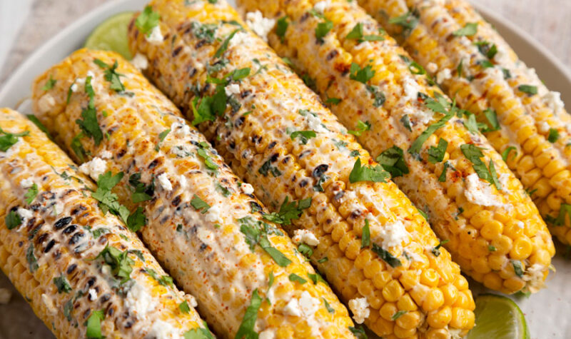 Corn on the cob (elote) covered in mayo and spices