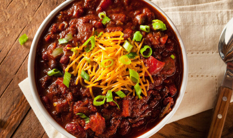 Veggie Chili in a white bowl topped with cheese
