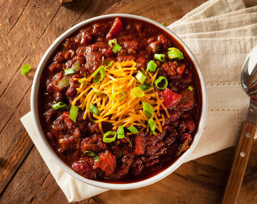 Veggie Chili in a white bowl topped with cheese
