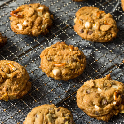A bunch of cookies with caramel, chocolate chips and other ingredients