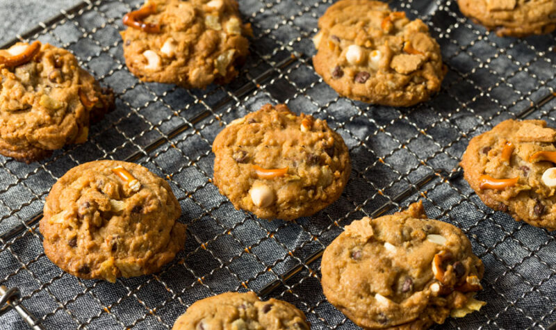 A bunch of cookies with caramel, chocolate chips and other ingredients