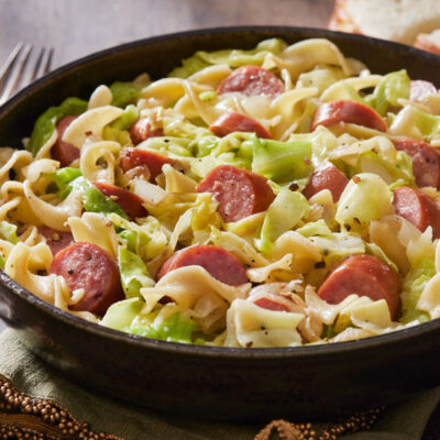 Haluski, a dish with egg noodles, sausage and cabbage in a skillet