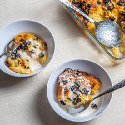 Bread pudding in 2 bowls with spoons