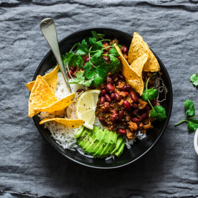 Taco rice bowl w/ corn, avocado, beans, beef and cilantro.