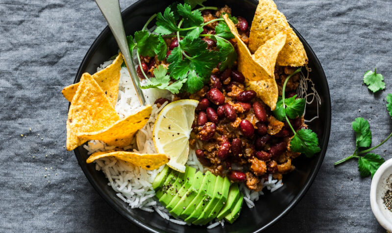 Taco rice bowl w/ corn, avocado, beans, beef and cilantro.