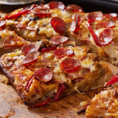 Detroit style pepperoni pizza on a cutting board