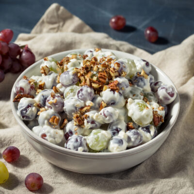 A grape salad in a bowl with grapes on the side